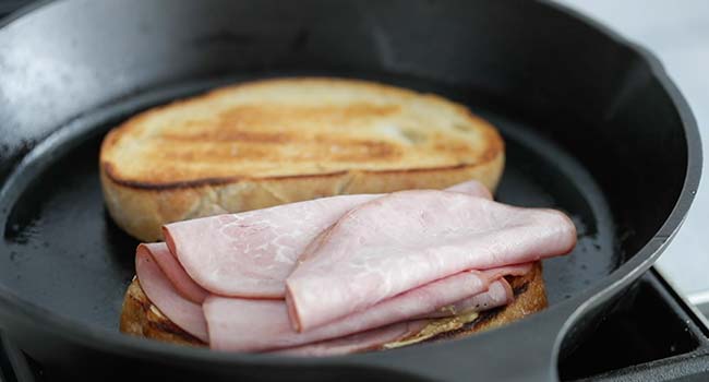 slices of ham on toast in a pan