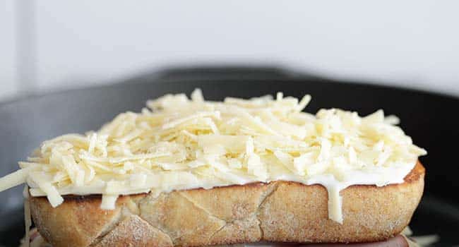 toast topped off with bechamel and shredded comte cheese