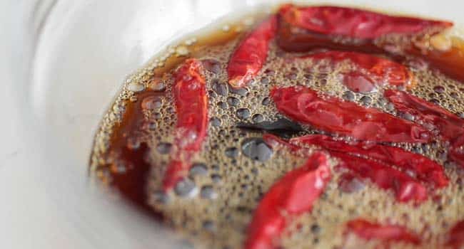 dried thai chiles in a bowl with soy sauce