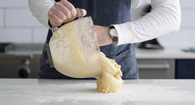 adding brioche dough to a floured surface 