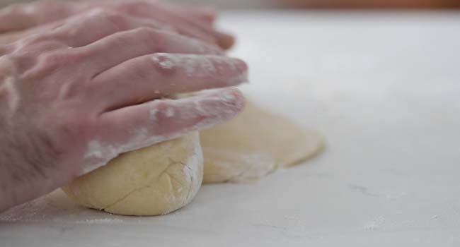 rolling up dough to form a loaf