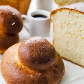 homemade brioche bun and a loaf of brioche sliced in half
