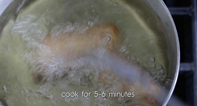 frying battered fish in a pot of oil