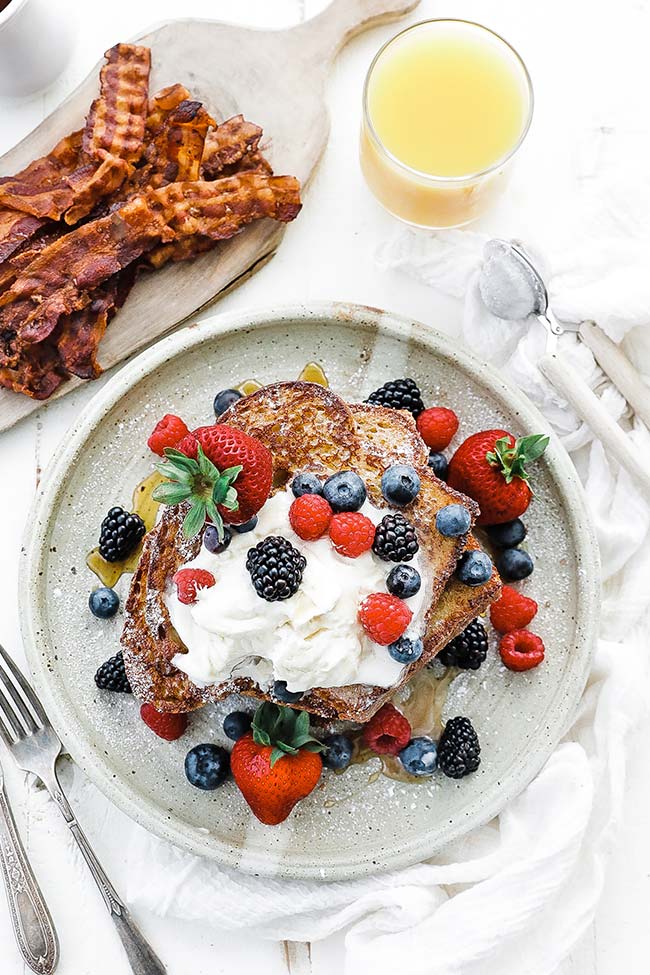 brioche french toast with berries, bacon and orange juice