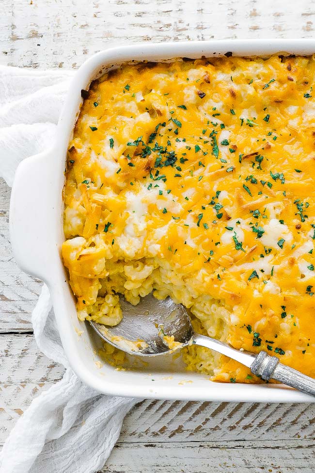 macaroni and cheese casserole dish with a large spoonful taken out