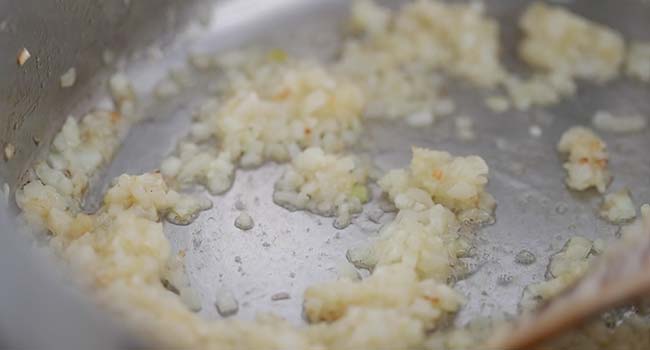 sautéing garlic and onions in a large pot