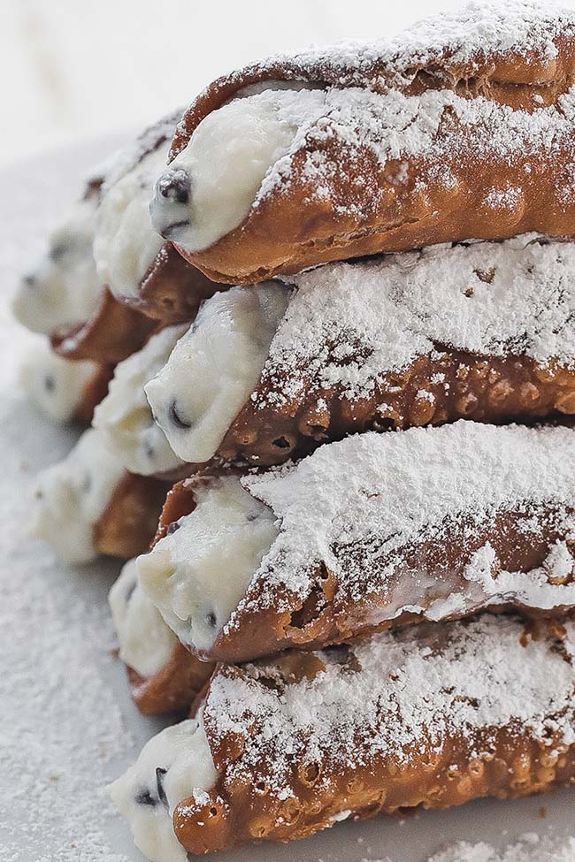 filled and cooked cannolis on a plate