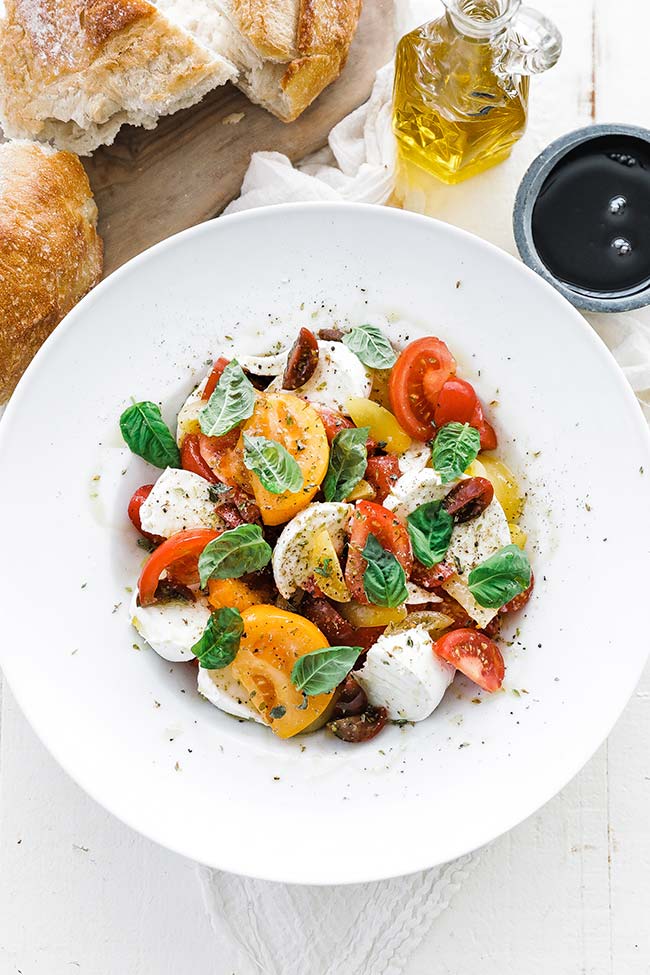 tomato caprese salad in a bowl with bread