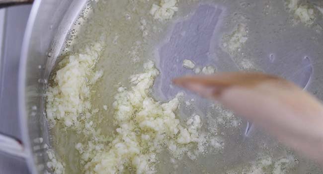 cooking garlic in olive oil in a large pot