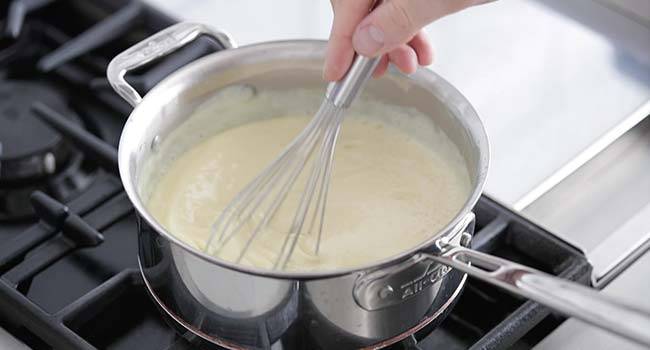 whisking custard in a sauce pot 