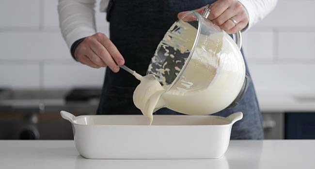 adding merengue custard to a casserole dish 