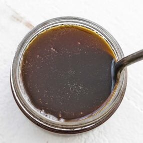 jar of dark rum sauce with a spoon