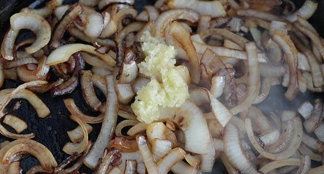 cooking chopped garlic with caramelized onions