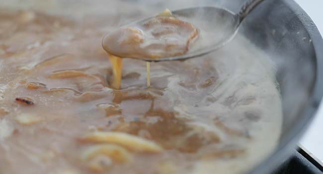 spoonful of onion gravy in a pan