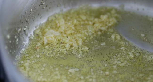 sautéing garlic in olive oil in a pot