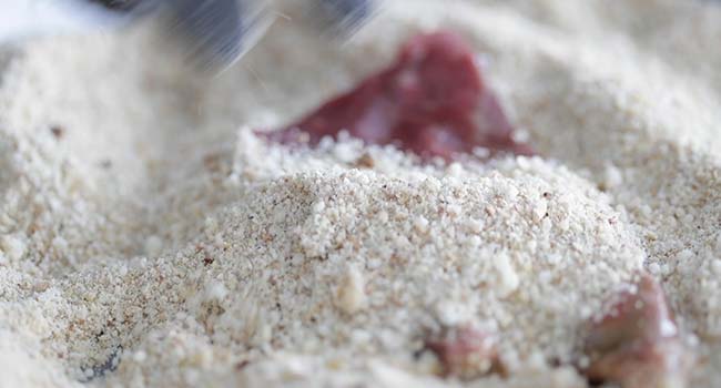 coating the sliced beef in olive oil and breadcrumbs