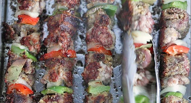cooking beef spiedini kebabs on a flat top grill
