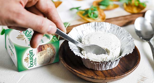 taking a scoop of boursin cheese