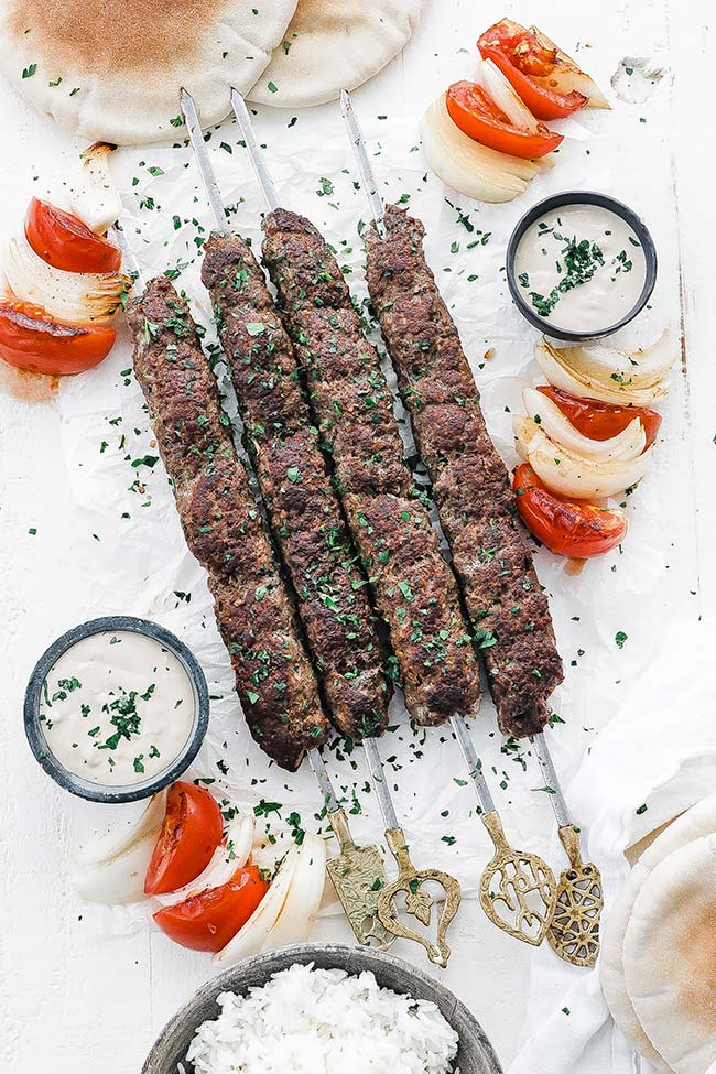 beef and lamb kofta kebab with tahini sauce and vegetables