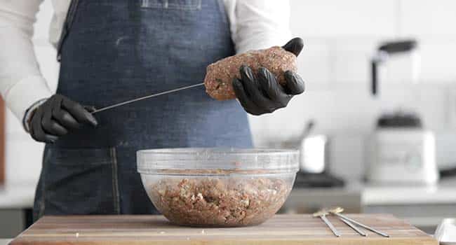 forming a large ball of beef on top of a skewer