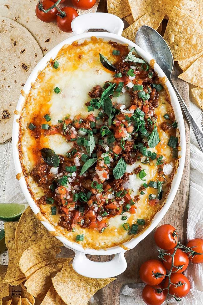 homemade queso dip with chips and tomatoes