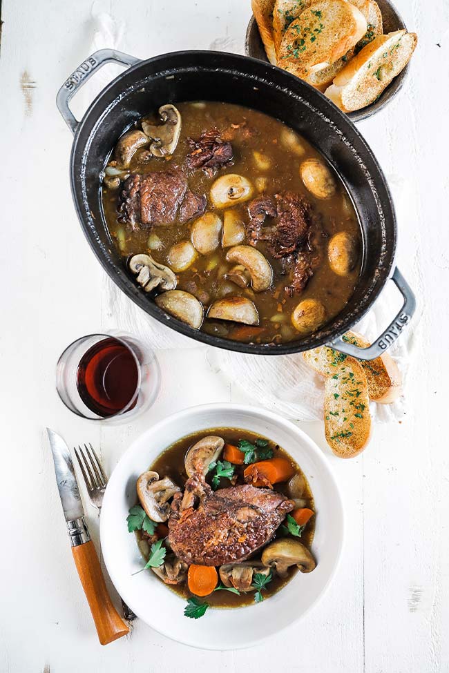 coq au vin in a cocotte with bread