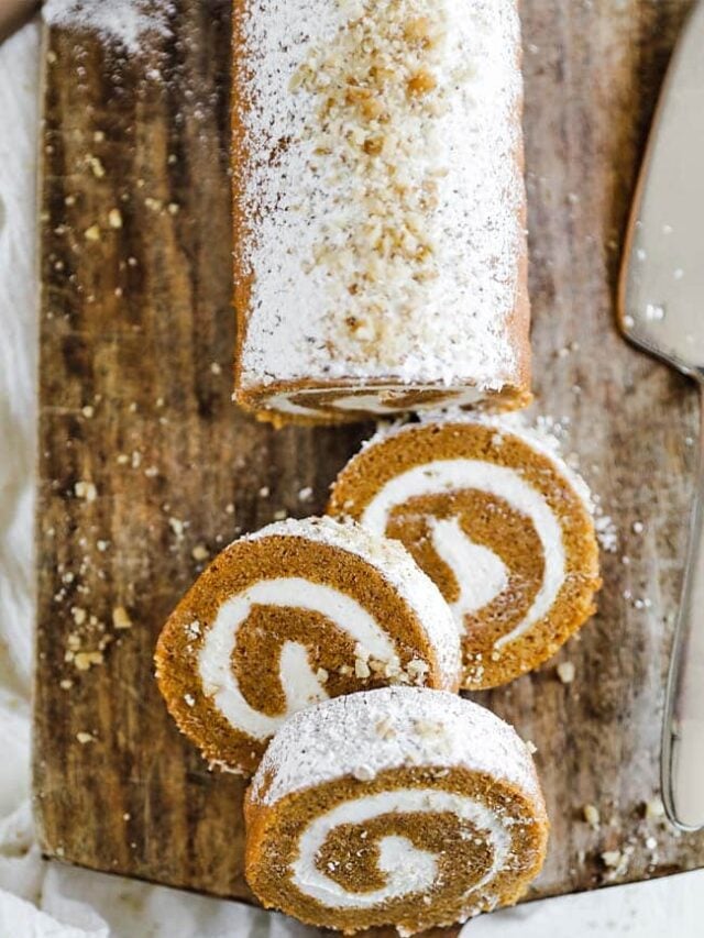 pumpkin roll log on a cutting board with slices