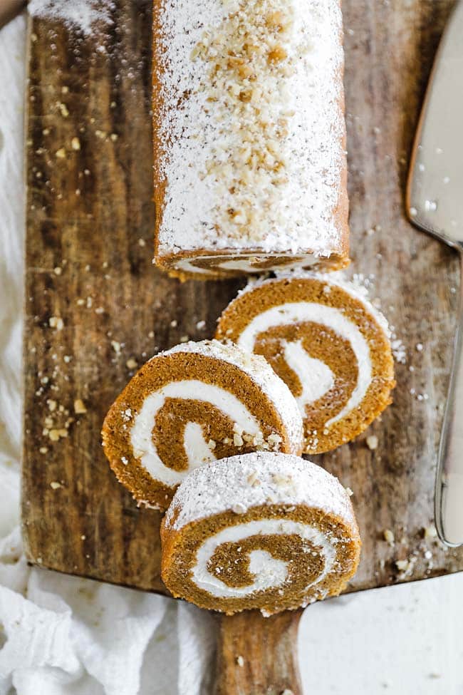 pumpkin roll log on a cutting board with slices