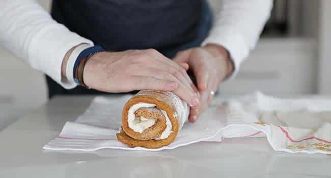 rolling up a pumpkin roll