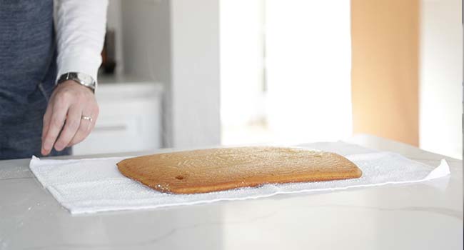 pumpkin sheet cake on a powdered sugar towel