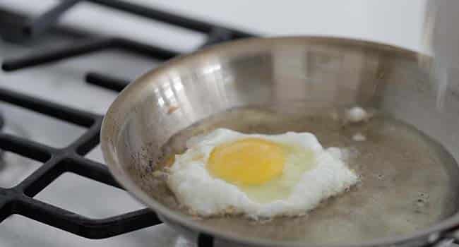 frying an egg in a pan