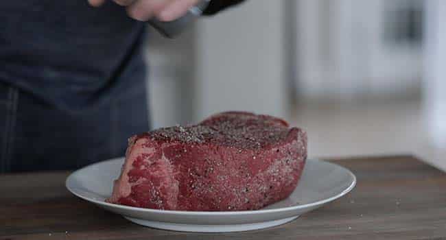 seasoning beef with salt and pepper