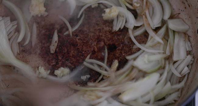 cooked beef in a pot with onions