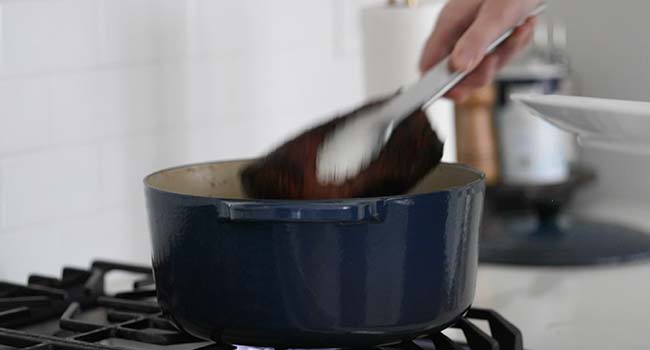 slow braising a chunk of beef in a pot