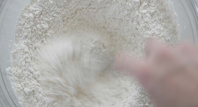 whisking together flour in a bowl