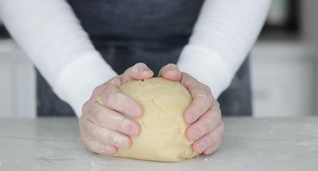 kneading cookie dough on a countertop