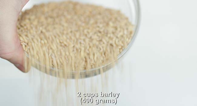 adding barley to a pot