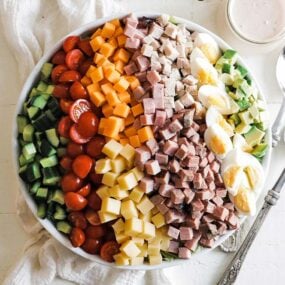 classic chef salad in a bowl with a thousand island dressing on the side