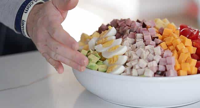 making a chef salad with toppings