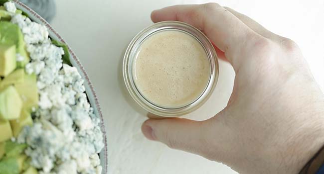 serving dressing with a salad