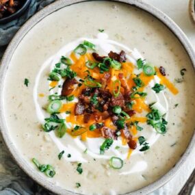 bowl of potato soup with toppings