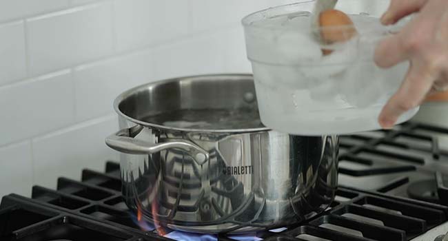 removed boiled eggs from a pot of boiling water into an ice bath