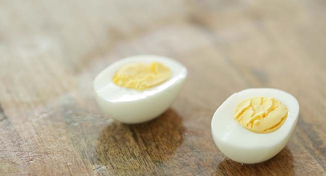 slicing a hard boiled egg in half