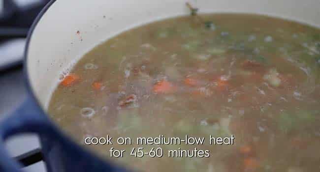 cooking cowpeas in a pot with chicken stock and vegetables