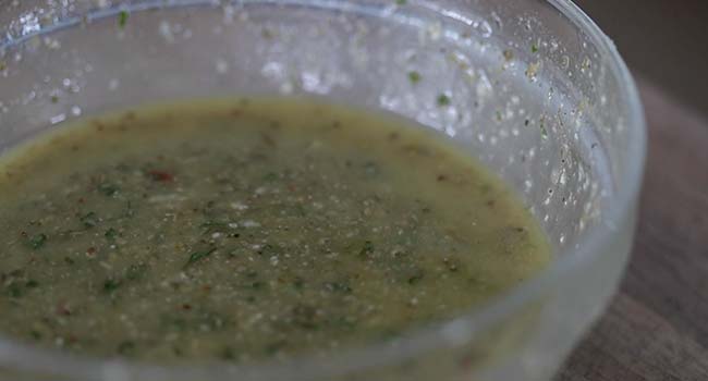 whisking together a Homemade Italian Dressing in a bowl