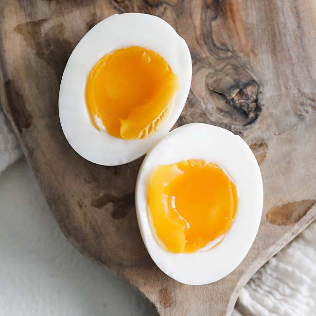 medium-boiled egg on a cutting board