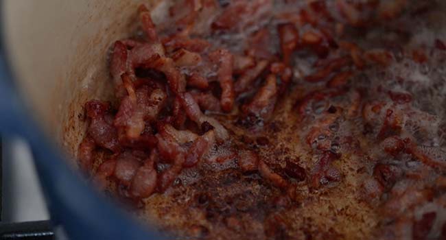 crispy bacon lardons cooking in a pot