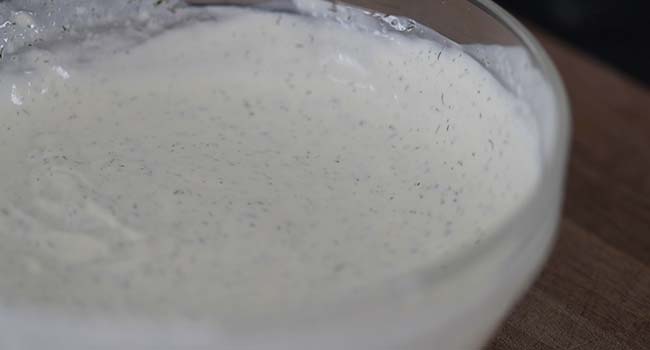 whisking a bowl of homemade ranch dressing