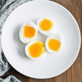soft boiled eggs sliced in half on a plate