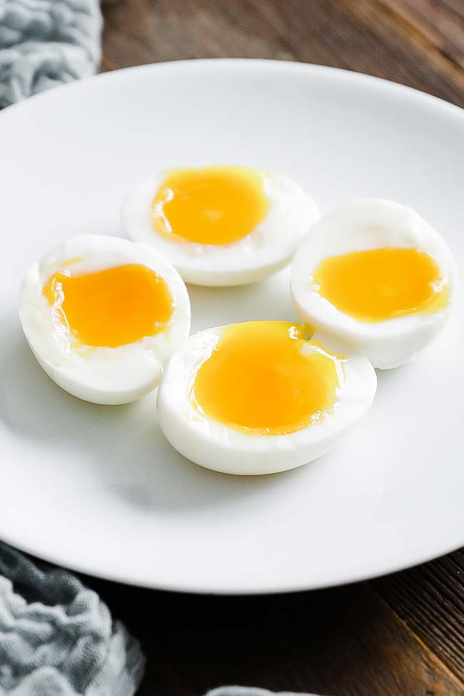 jammy soft boiled eggs on a plate